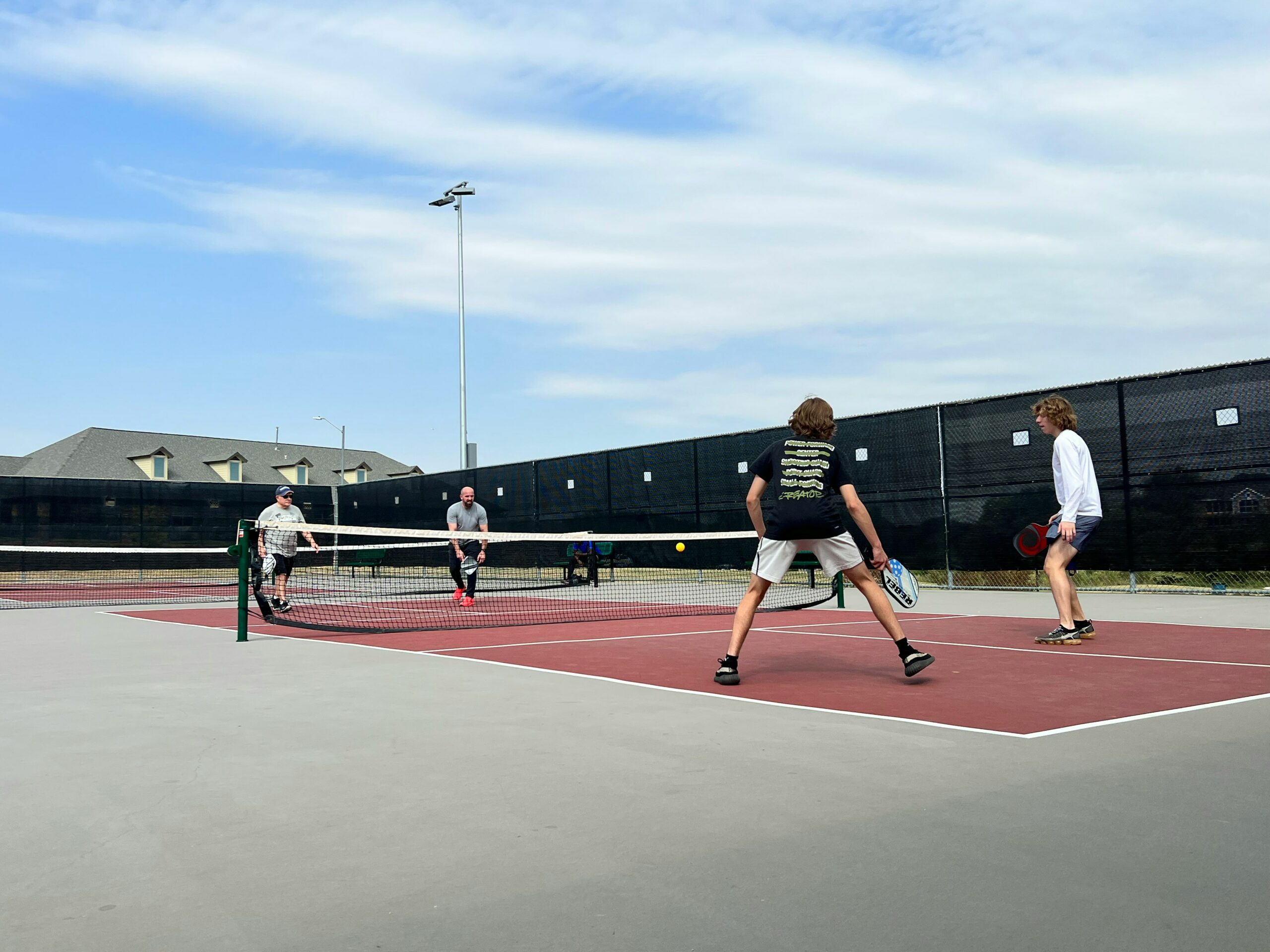 Four people playing Pickle Ball